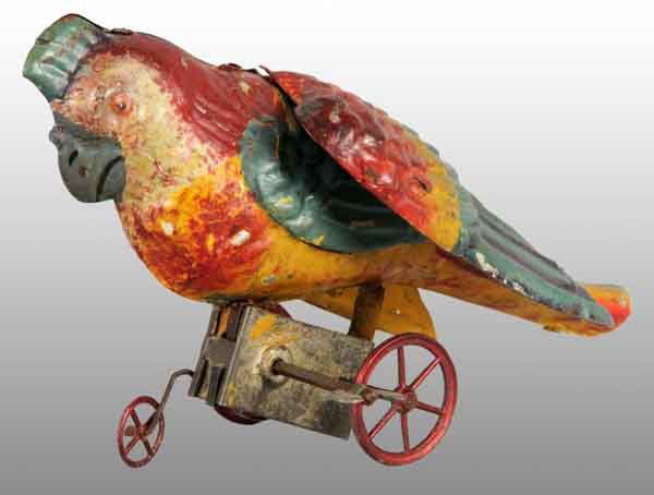 Tin Hand-Painted Parrot Wind-Up Toy.: Description German. Working. Beautiful tri-colored paint in yellow, red, and blue with grey beak. Nice early mechanism with three spoked wheels, including red guide wheel in front. Minimal paint loss