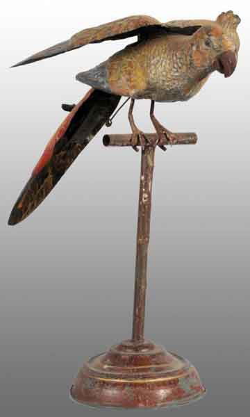 Tin Hand-Painted Parrot Wind-Up Toy.: Description German. Working. When wound, bird goes up and down and his articulated wings flap. Attached to a tin perch which is connected to a tin circular base. Moderate overall wear. Condition (Very