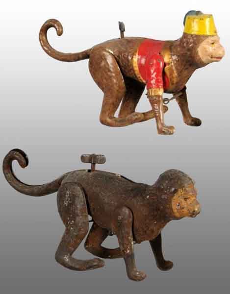 Lot of 2: Tin Hand-Painted Monkey Wind-Up Toys.: Description German. Working. Includes two different versions of the same toy. One is painted brown with no hat and the other is more colorful with red jacket and yellow hat with blue tassel. Brown mon