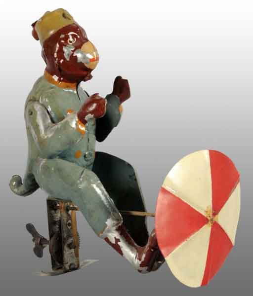 Tin Hand-Painted Monkey Wind-Up Toy.: Description German. Working. When wound, umbrella in front spins around. Some spots of paint loss, especially to arms and legs. Front umbrella has been replaced as well as metal stand under mechanism.