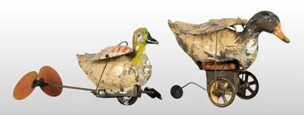 Lot of 2: Tin Hand-Painted Duck Wind-Up Toys.: Description German. Working. One has a third guide wheel on bottom and other has what appears to be original cardboard propellers. Both have articulated flapping wings, one has bellows that makes a sl