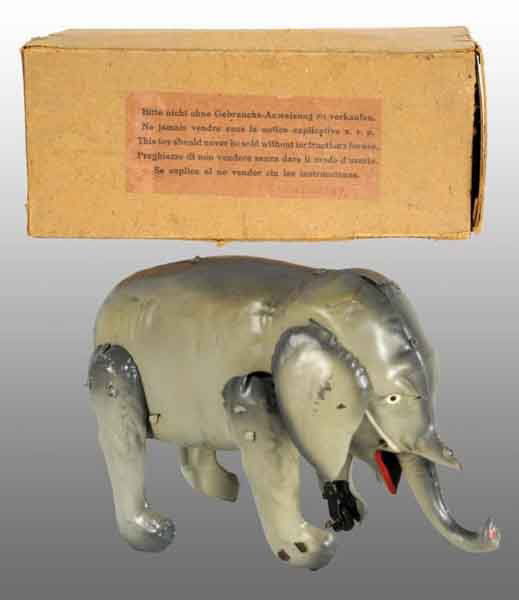 Tin Hand-Painted Elephant Wind-Up Toy.: Description German. Working. When wound, elephant moves forward and trunk goes up and down. There are two wheels on the front of elephant's leg to facilitate movement. Original ears with very little w