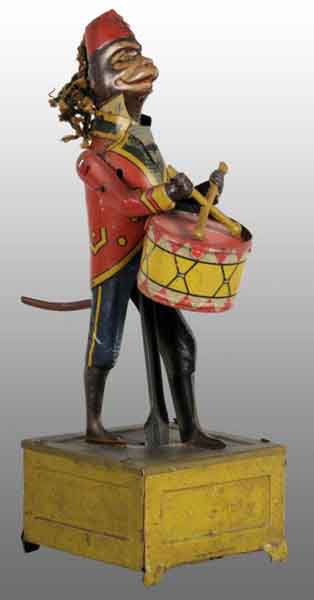Tin Litho Monkey Playing Drum Wind-Up Toy.: Description German. Working. Marked "Made in Germany" with 6.5-inch tall monkey playing on base. When wound, monkey's arms go up and down while he beats drum with drumsticks. Drum head is possibly rep