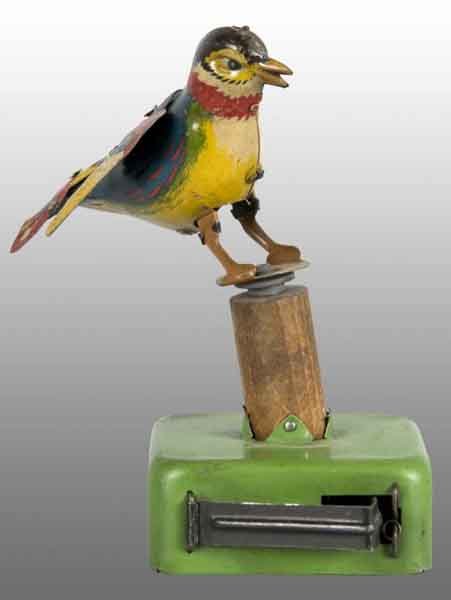Tin Litho Bird Push-Activated Toy.: Description German. Marked "Made in Germany" on underside of belly. Beautifully colored lithography on bird resting on stump. When lever is squeezed, bird moves back and forth and emits squeaking soun