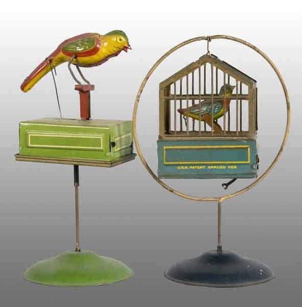 Lot of 2: Tin Litho Birdcage Wind-Up Toys.: Description German. Toy with bird in cage does not have working bellows but other toy, when wound, chirps. Very nice lithography with one replaced wire hook on metal wire attached to birdcage. Conditi
