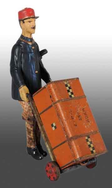 Tin Lehmann Adam the Porter Wind-Up Toy.: Description German. Working. Includes original E.P.L. 689 trunk. Toy has some restoration on hat, arms, hands, and face along with some pitting to the metal on legs and cart. Condition (Very Good). Si