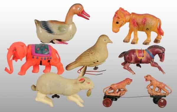 Lot of 7: Celluloid Animal Wind-Up Toys.: Description Pre-war Japanese. All appear to be in working condition. Includes one waddling duck, one elephant, one rabbit with carrot in mouth, one bird, one donkey, and one very unusual lion fighting
