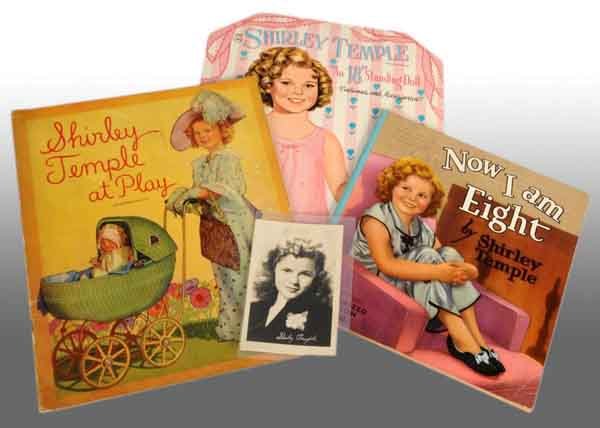 Lot of 4: Shirley Temple Items.: Description Lot contains three Saalfield Shirley Temple books. A complete and uncut 1959 paper doll book, a 1937 "Now I Am Eight" storybook, and a 1935 "Shirley Temple at Play" book. Also includes a 1