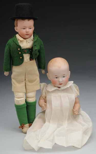 Lot of 2: Gebruder Heubach Chaacters.: Description Germany, Ca. 1910. Bisque socket head incised "7602" with Square Mark, painted hair, intaglio eyes, pouty mouth, composition baby body (soil and wear), vintage baby gown. Bisque shoulder i