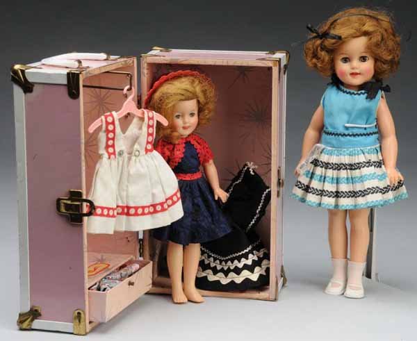 Lot of Two Shirley Temple Dolls.: Description American, Ca. 1950s. Vinyl Shirley Temple marked Ideal Doll ST-15. Clear sleeping eyes with eyelashes, full hair, rosy cheeks, original tagged Shirley Temple dress, replaced shoes and sock