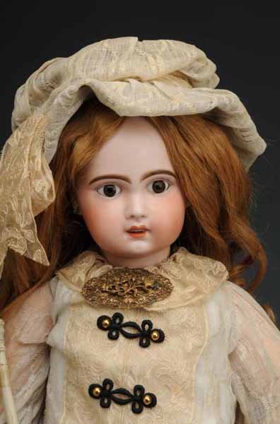 Jumeau Doll with Open Mouth Doll: Description France, Ca. 1900. Bisque socket head (chunk size of a quarter out of back socket), paperweight eyes, painted upper and lower eyelashes, open mouth with upper teeth, pierced ears, original 