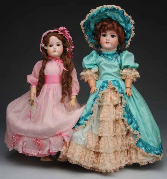 Lot of 2: German Bisque Dolls.: Description Germany, Ca. 1900. 1912 Cuno & Otto Dressel, bisque socket head, original human hair wig, set glass eyes, open mouth, jointed composition body, dressed. Heinrich Handwerck, bisque socket h