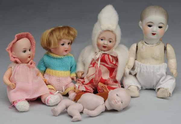 Lot of 5: Bisque Dolls.: Description Two Japanese made babies (one with eye chip and repaired neck) on composition bodies. Two German babies on composition bodies, marked "A.M. 390", and "A.M. 971". All-bisque Germany baby wi