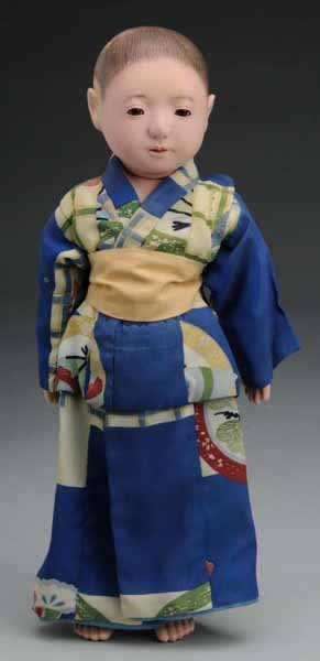 Japanese Traditional Papier-Mache Ichimatsu.: Description Ca. 1900. Papier-Mache swivel head on shoulder plate, inset glass eyes, painted hair, cloth midsection, papier-mache hips, lower legs and arms, cloth upper arms and legs. All original in k