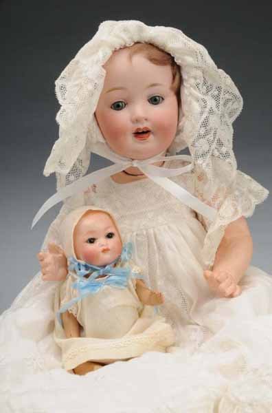 Lot of 2: Bisque Babies.: Description Germany, Ca. 1920. Bisque socket head incised "PM 914 Germany", made by Otto Reinecke, sleeping eyes, open mouth with teeth, composition baby body, lovely clothing. Bisque socket head inci