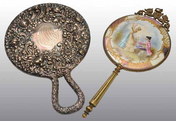Lot of 2: Hand Mirrors.: Description One with an enamel painting of a lady and man in the woods with a beveled mirror. Second is a floral patterned mirror, some darkening of the mirror. Condition (Excellent). Size 9" L., Mirr