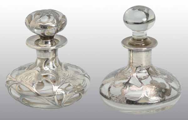 Lot of 2: Sterling Silver Overlay Perfume Bottles.: Description Both include original stoppers with floral decoration and no damage. Condition (Excellent). Size Largest: 3 - 1/4" T.