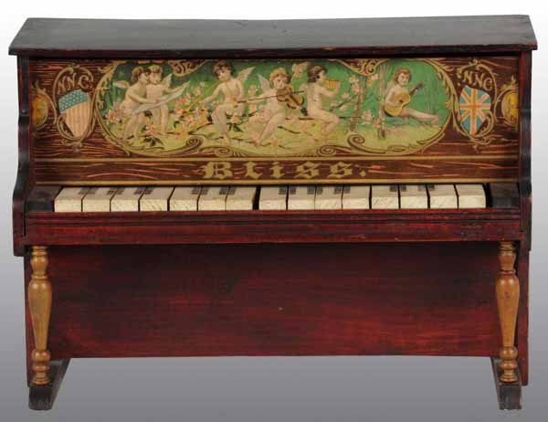 Wooden Bliss Piano Toy.: Description Working. Beautiful decals on front of angels playing instruments along with English and American flags. Some wear to keys with scratching to roof. Condition (Very Good). Size 17" x 12".