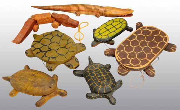 Lot of 7: Wooden Animal Pull Toys.: Description American. Includes five turtles and two alligator toys. Very primitive and in a folk art style. Condition (Very Good - Excellent). Size Largest: 24" L.