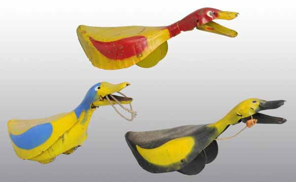 Lot of 3: Tin Duck Pull Toys.: Description American. Circa 1920s. Includes three different color variations of the same toy. Moderate scratching and wear overall. Includes two original, partial boxes marked "The Hungry Duck". Condi