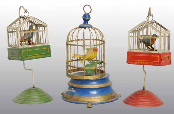 Lot of 3: Bird in Cage Wind-Up Toys.: Description German. Includes one repainted toy and two different lithographed versions of the same toy. All have bellows but only one still chirps. Condition (Very Good). Size All: 7" T.