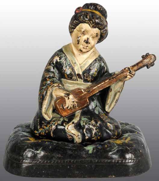 Cast Iron Geisha on Cushion Doorstop.: Description Made by Hubley, cat. #63. Full-figure Geisha on floral cushion wearing a kimono. Condition (Very Good). Size 7 - 5/8" x 6 - 1/4".