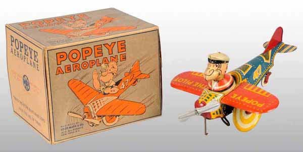 Marx Popeye Aeroplane Toy in Original Box.: Circa 1935. Tin litho. Wind-up. Made by Louis Marx Company. Working. Early version of Popeye the Pilot. Lithographed colors on toy are very strong with some wear to wheels. Includes very rare, origina