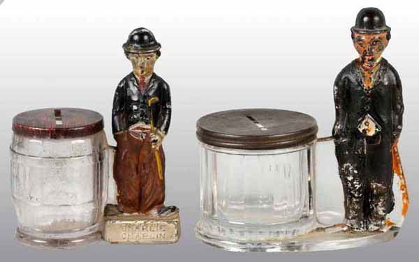 Lot of 2: Glass Charlie Chaplin Candy Containers.: Also still banks. The smaller version is marked on underside Geo. Borgfeldt Sole License and has great paint with original lithographed tin closure and no chips or cracks. The larger version is marked