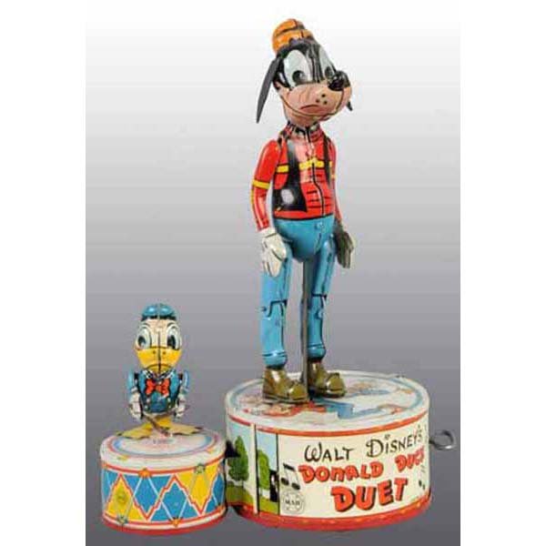Tin Marx Walt Disney Donald Duck Duet Wind-Up Toy: Working. Marked "Copyright 1946 Walt Disney Productions". Toy is all original except for Goofy's rubber ears. Some moderate wear overall. 10" T.