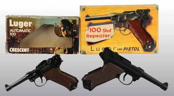 Lot of 2: Luger-Style Toy Cap Guns.: Includes original boxes. Crescent Luger, unfired. Luger 100 shot repeater, unused. Largest: 8" L.