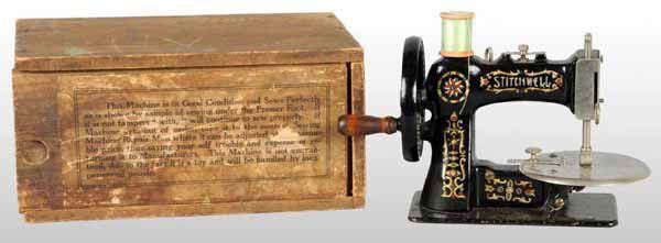 Cast Iron Stitchwell Child's Toy Sewing Machine.: Includes original wooden box. 300 8" x 6".