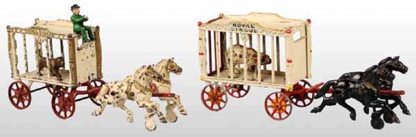 Lot of 2: Cast Iron Hubley Cage Wagon Toys.: Includes one polar bear, one lion, and one figure. The large wagon's cage appears to be repainted and is missing its driver. The smaller wagon's lion and driver figures appear to be replacements. Larg