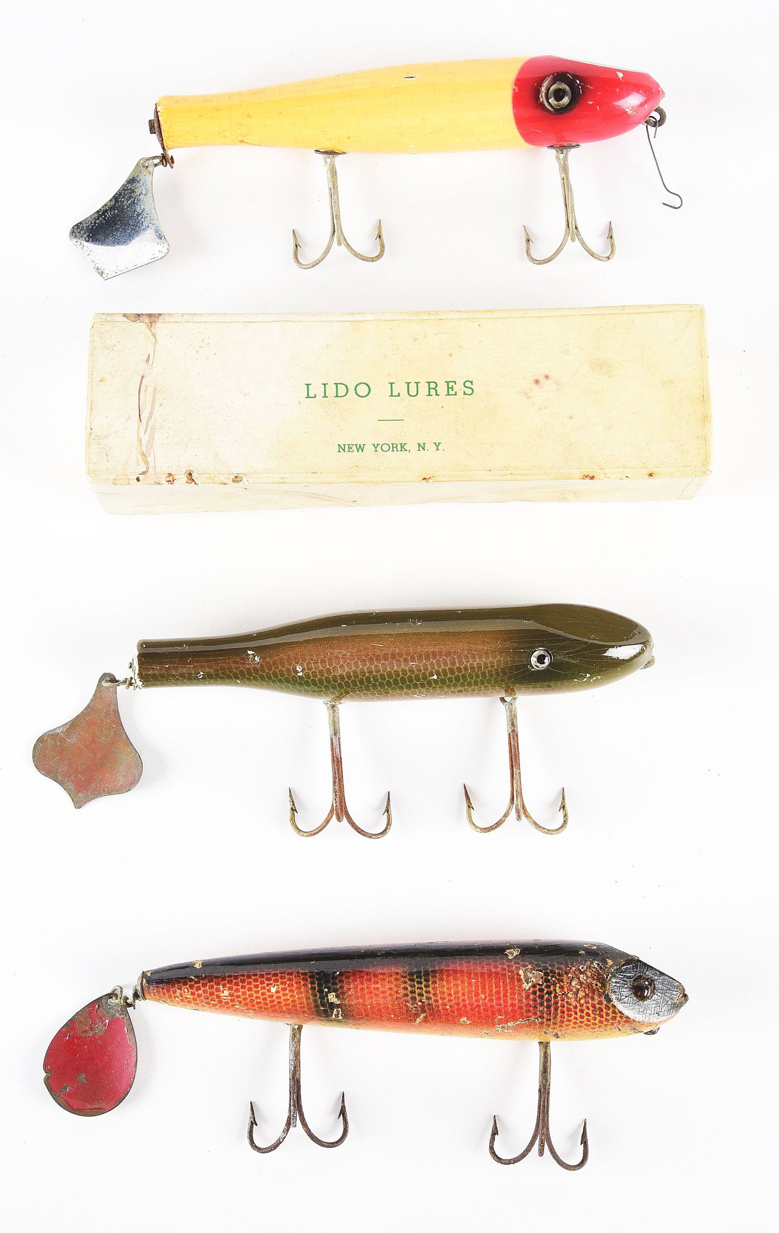 LOT OF 3: LIDO LURES.: Lot of 3 fishing lures. Includes a Ossur flattail, a Lido red and white flattail in original box, and a Lido flattail green and brown lure with scale finish. CONDITION: Very good to excellent.