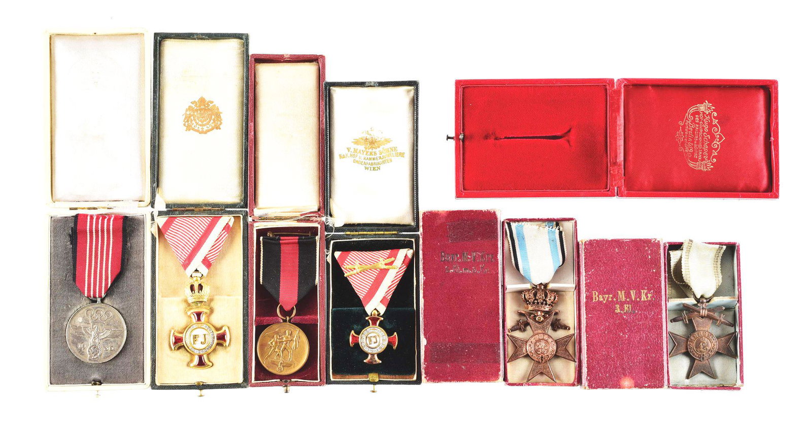 LOT OF 7: IMPERIAL GERMAN AND THIRD REICH CASED BADGES: Lot contains: Third Reich cased 1936 Olympic Games in Berlin "Fur Verdienstvolle Mitarbeit" (meritorious cooperation), a cased Third Reich Sudetenland Medal (1. Oktober 1938), and what appears to be a