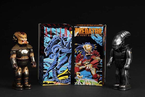 Lot of 2: Tin Alien & Predator Wind-Up Toys.: Description Japanese. Made by Billiken. Includes two original boxes. Condition (Near Mint). Size Both: 9" T.