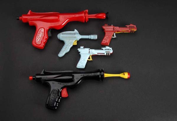 Lot of 5: Plastic Space Guns Toys.: Description Includes three clicker guns, one rocket gun, and one space patrol dart gun. Condition (Very Good). Size Largest: 6" L.