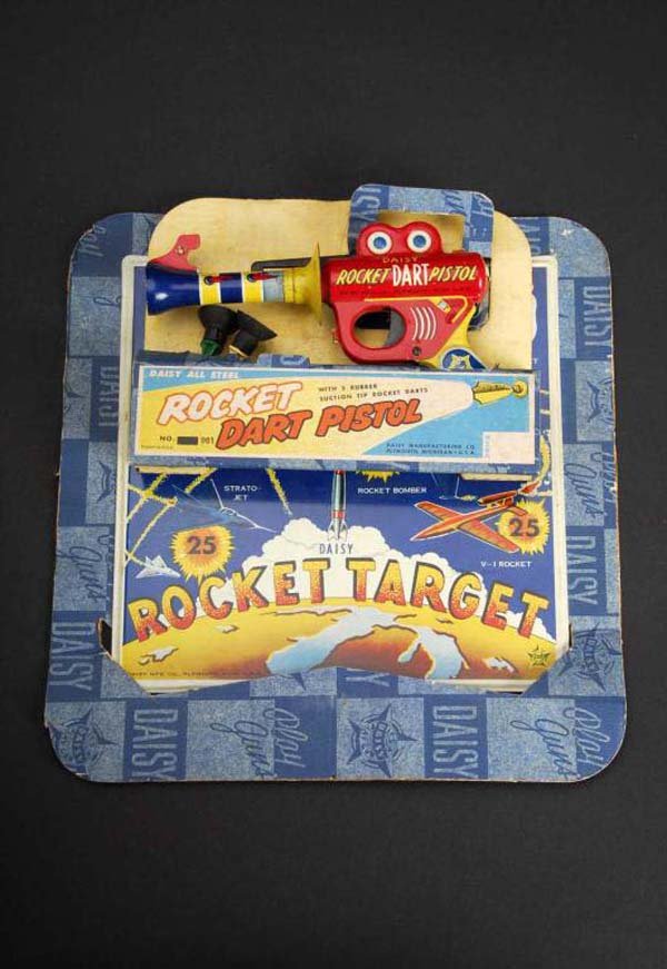 Rocket Dart Pistol Toy.: Description American. Made by Daisy. Working. When darts are loaded, gun fires dart at target. Includes original card, target, and two darts. Condition (Very Good - Excellent). Size Card: 12" x 12".