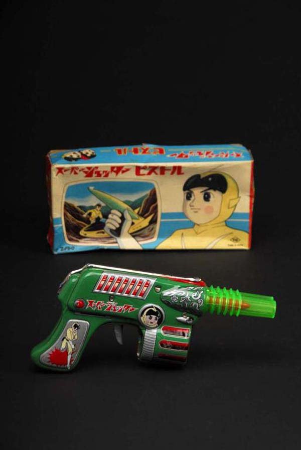 Super Jetter Pistol Toy.: Description Japanese. Made by Nomura. Working. When trigger is pulled, gun makes clicking sound and the two rockets inside barrel reciprocate. Some scratching on one side of barrel. Includes original 