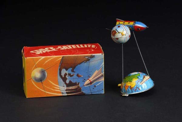 Tin Space Satellite Lever-Activated Toy.: Description German. Beautiful lithography with spaceship on one side and satellite on the other. Includes original box marked "RN". Condition (Excellent). Size 16" L.