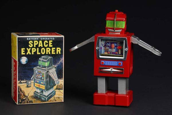 Space Explorer.: Description Japanese. Made by Masudaya. Red version. Working. When turned on by button on top of head, "TV-looking" box rises up to expose legs, arms, and a head. Then the TV screen drops to reveal an