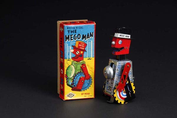 Tin Mego Man.: Description Japanese. Made by SY. When in operation, wind-up robot advances forward while arms and legs move back and forth, head titles back and forth, and a pin lowers on bottom that makes robot tur