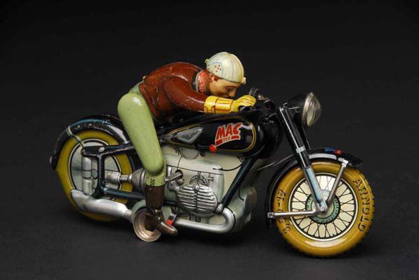 Tin MAC 700 Motorcycle Wind-Up Toy.: Description German. Working. When in operation, driver jumps off and then gets back on cycle. Moderate overall wear, especially where right leg meets the gas tank. Condition (Very Good). Size 8" L.