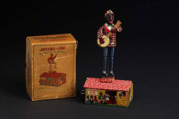 Tin Unique Art Jazzbo Jim Roof Wind-Up Toy.: Description American. Working. Beautiful lithography around base. Original arms and banjo. One four-inch crease on top of roof and minor scratching to figure. Includes complete original box with cardb