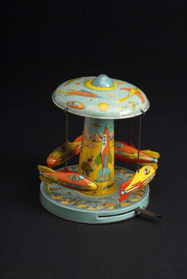 Tin Chein Space Ride Lever Action Toy.: Description American. Working. Rockets revolve around base. Beautiful lithography of spacemen, rockets, and space travel. Slight fading throughout with one small dent in center where metal is tabbed t