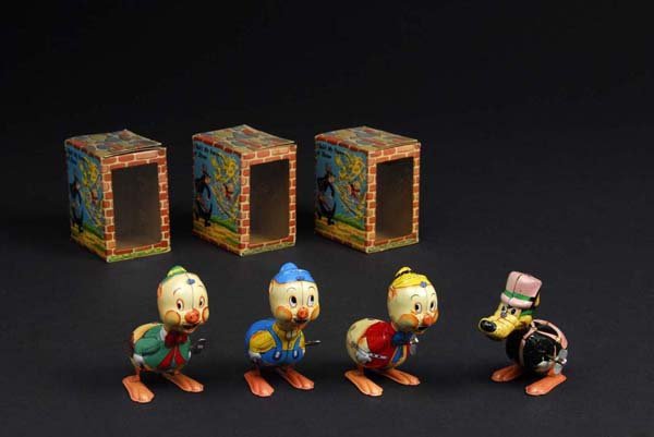 Lot of 4: Linemar Disney Big Bad Wolf & 3 Pigs.: Description Japanese. Tin. Wind-up mechanisms are working. Marked on back "Walt Disney Productions". When wound, toys hops. One pig is playing a flute, one is playing a violin, and one has a trough. T
