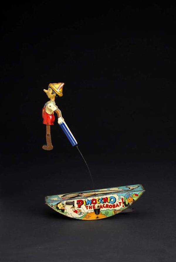 Tin Marx Pinocchio Acrobat Wind-Up Toy.: Description American. Pressed cardboard legs. Marked "1939 Walt Disney Productions". Moderate scratching throughout. Condition (Good - Very Good). Size 15" T.