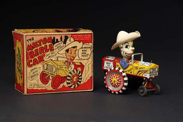 Tin Marx Milton Berle Car Toy.: Description American. Working. All tin with plastic hat. Head spins when toy is wound. Includes original box missing two inside flaps and one end flap is detached but present. Condition (Very Good - E