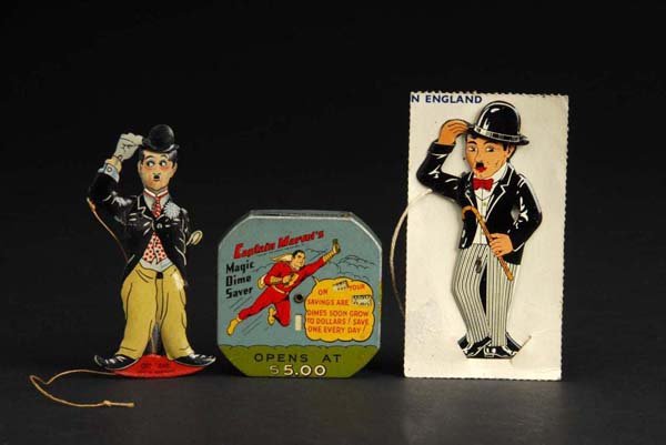 Lot of 3: Charlie Chaplin & Captain Marvel Items.: Description Includes one Captain Marvel Magic Dime Bank with original trap and two Charlie Chaplin Hat Tippers. Slight wear overall. Condition (Excellent). Size Hat Tippers: 4" L.