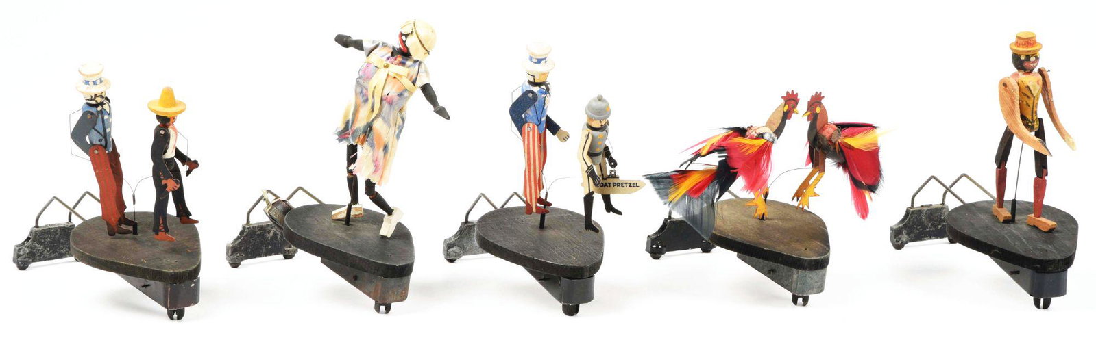 LOT OF 5: VICTROLA DANCING TOYS.: This is a lot of five Victrola dancing toys, consisting of a Shamandy, dancers, Uncle Sam, Uncle Sam and U-boat captain, fighting chickens and dancing Rastus. All five dancing toys have areas of paint