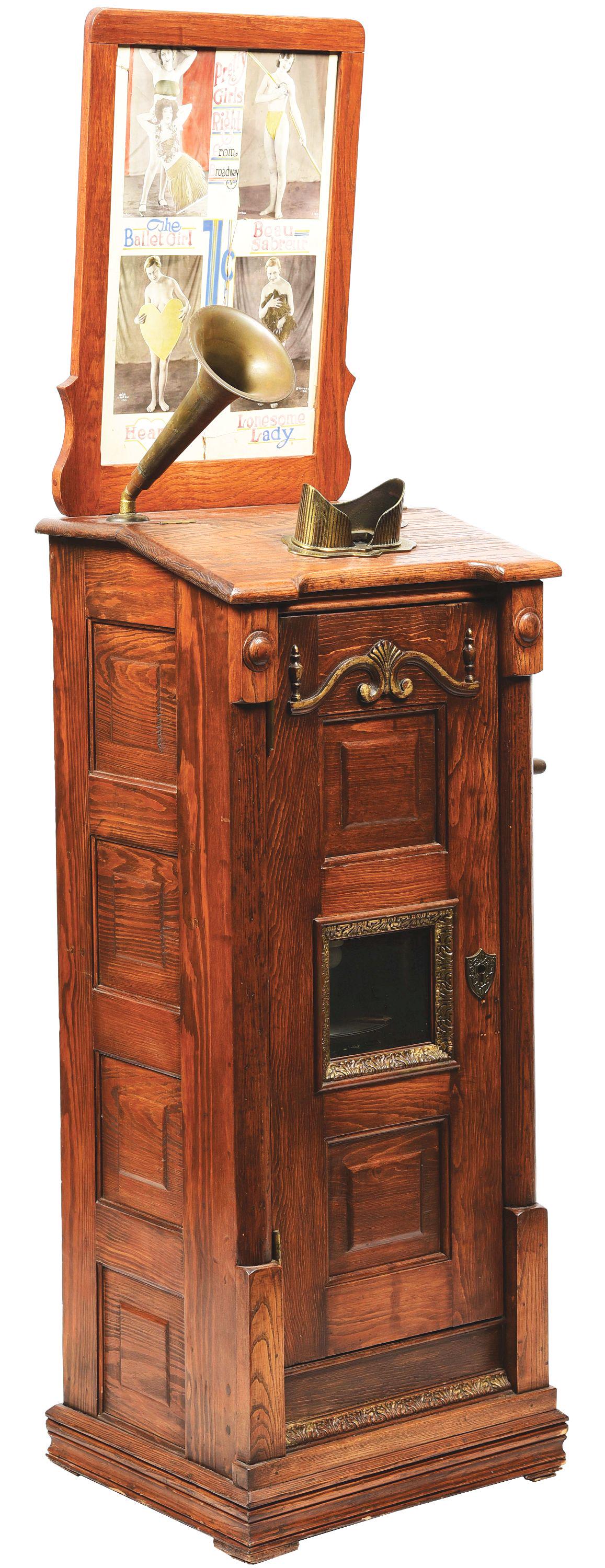 1¢ RARE DROP CARD VIEWER WITH MUSIC.: This is a very rare drop card stereo viewer machine in oak with raised panels. This unusual example, maker unknown, has the added feature of a Victor turntable and recorded record to accompany the vie